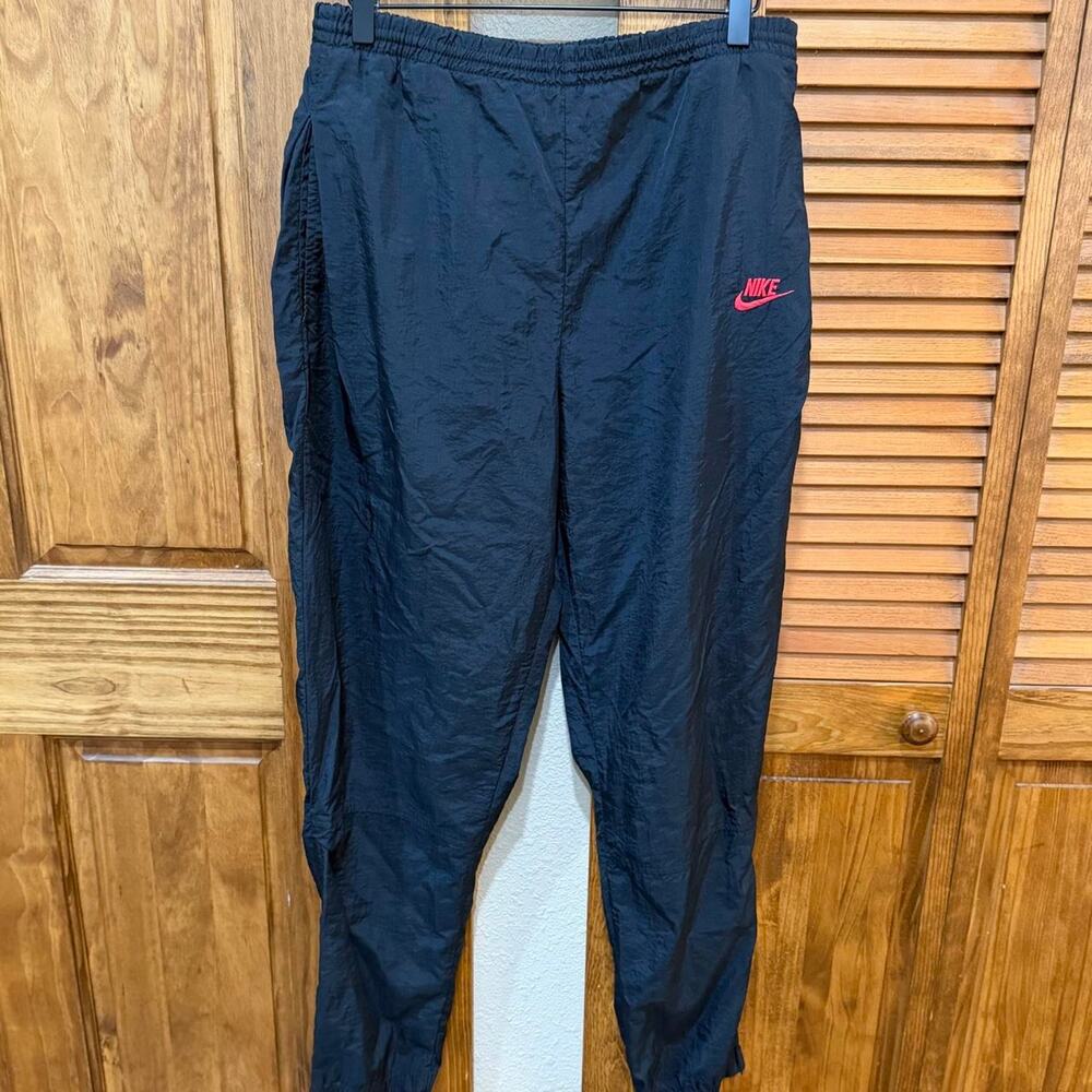 Vintage Nike black nylon wind pants with Nike logo on back pocket